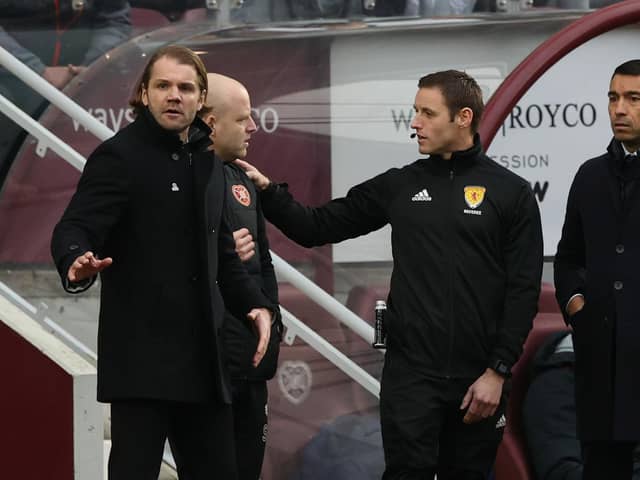 Hearts manager Robbie Neilson and Rangers boss Giovanni Van Bronckhorst both speaking with the fourth official during the match at Tynecastle. Picture: SNS