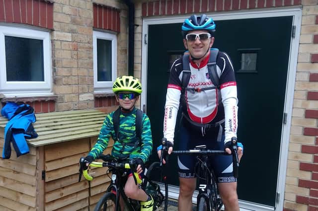 Lewis and his dad at home before setting off on their epic cycle on Thursday.