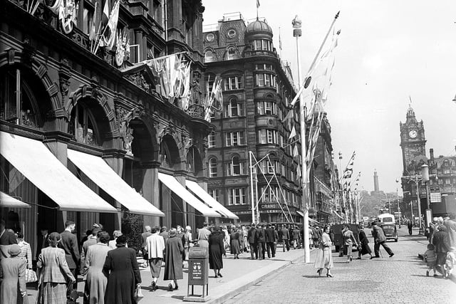 In honour of Queen Elizabeth II visiting Edinburgh, coronation decorations adorn the East End of Princes Street, including the famous department store. Year: 1953