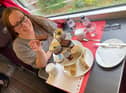 Pam Aldred prepares to enjoy LNER's luxury afternoon tea as the country whizzes by at 125mph