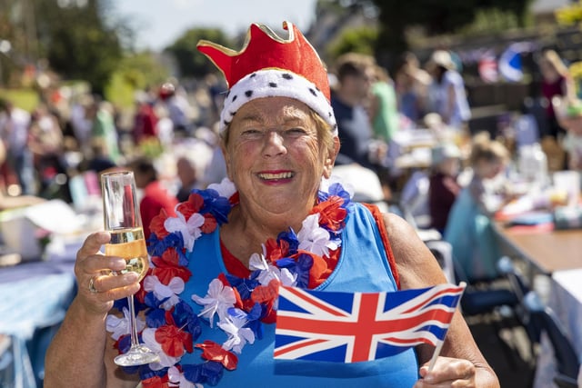 Sheila Mann enjoys a glass of fizz as residents of Netherby Drive in Trinity celebrate the Platinum Jubilee. (Photo by Robert Perry/Getty Images)
