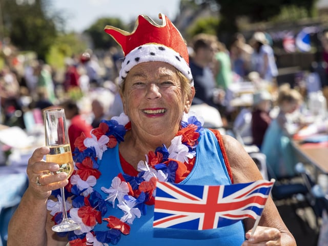 Sheila Mann enjoys a glass of fizz as residents of Netherby Drive in Trinity celebrate the Platinum Jubilee. (Photo by Robert Perry/Getty Images)