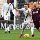 Alex Cochrane battles for possession with ex-Hearts midfielder Jason Holt in the recent Scottish Cup win over Livingston. Picture: SNS