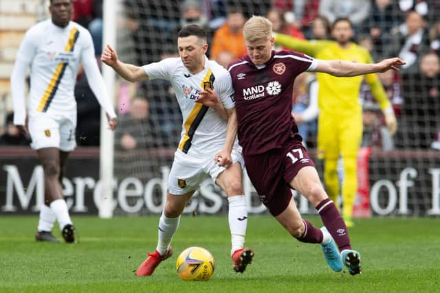 Alex Cochrane battles for possession with ex-Hearts midfielder Jason Holt in the recent Scottish Cup win over Livingston. Picture: SNS