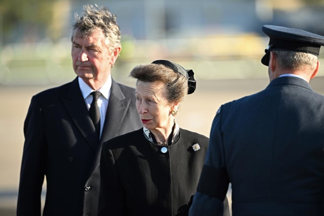 The Princess Royal and Vice Admiral Sir Tim Laurence watch as the coffin of Queen Elizabeth II is carried aboard an RAF aircraft on its journey from Edinburgh to Buckingham Palace, London, where it will lie at rest.