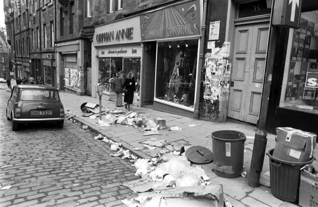 Rubbish in Cockburn Street in Edinburgh during the dustmen's strike in 1982. Familiar shops of yesteryear include Orphan Annie's and Ground Control.