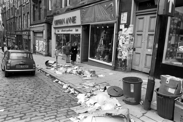 Rubbish in Cockburn Street in Edinburgh during the dustmen's strike in 1982. Familiar shops of yesteryear include Orphan Annie's and Ground Control.