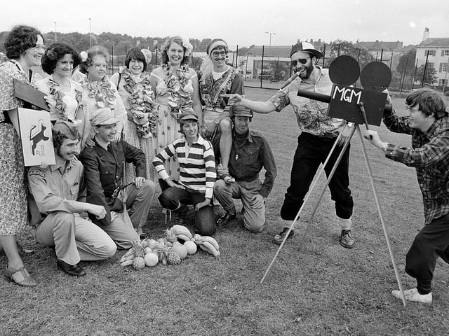 Carnival goers in fancy dress posing for the camera - spot any familiar faces?