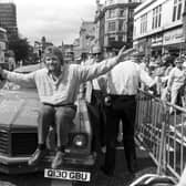 British businessman Richard Branson poses with his pink Pontiac car outside his new Virgin Megastore, opening in Edinburgh in July 1990.