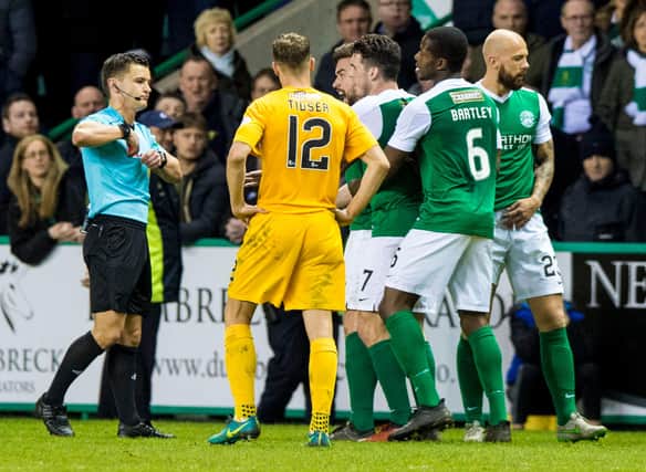 Nick Walsh sends off Darren McGregor (centre, partially hidden) during a Scottish Championship clash between Hibs and Morton in March 2017