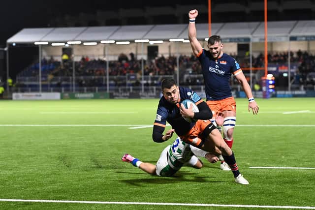 Matt Currie lifts an arm in celebration as Emiliano Boffelli scores Edinburgh's second try of the game.  (Photo by Paul Devlin / SNS Group)