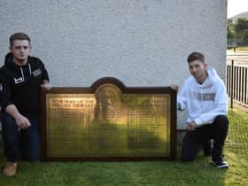 (L-R) James Mitchell and Daryl Huth with the restored memorial plaque.