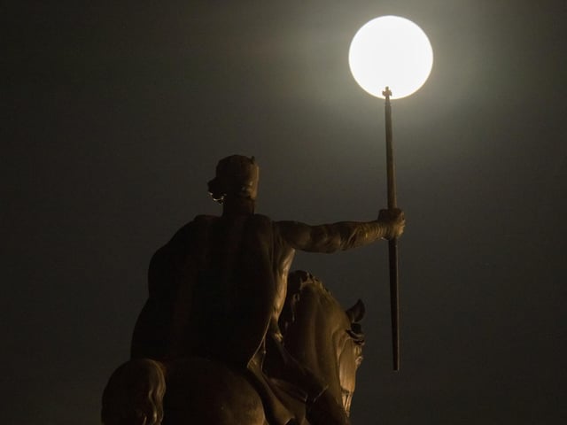 A supermoon rises behind sculpture of Tomislav of Croatia, the first Croatian king, in downtown Zagreb, Croatia, Tuesday, June 14, 2022. (AP Photo/Darko Bandic)