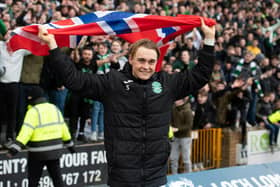 Elias Melkersen holds a Norwegian flag in front of the away end at Fir Park after scoring twice to help Hibs defeat Motherwell. Picture: SNS