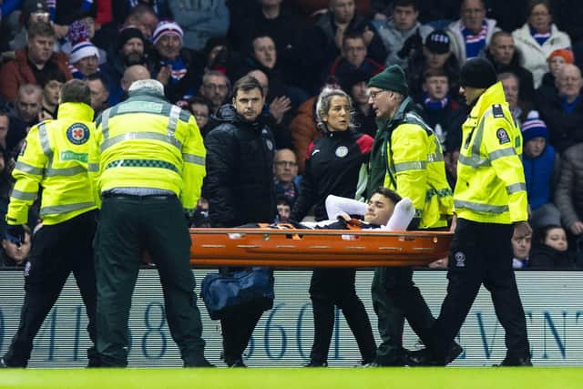 Magennis is forced off early through injury during his last game for St Mirren against Rangers at Ibrox