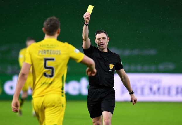 Ryan Porteous is booked by referee Steven McLean during a match between Celtic and Hibs at Celtic Park. Picture: SNS