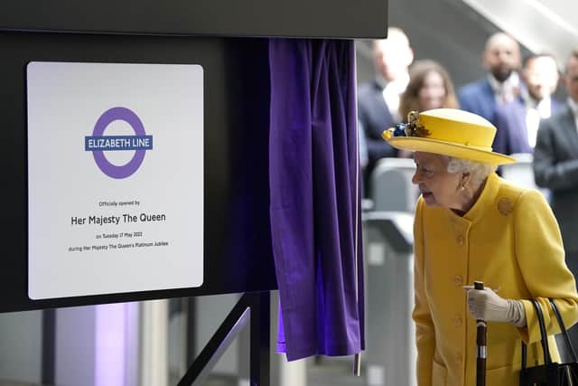 Queen Elizabeth II unveils a plaque to mark the Elizabeth line's official opening at Paddington station in London, to mark the completion of London's Crossrail project. Picture date: Tuesday May 17, 2022.
