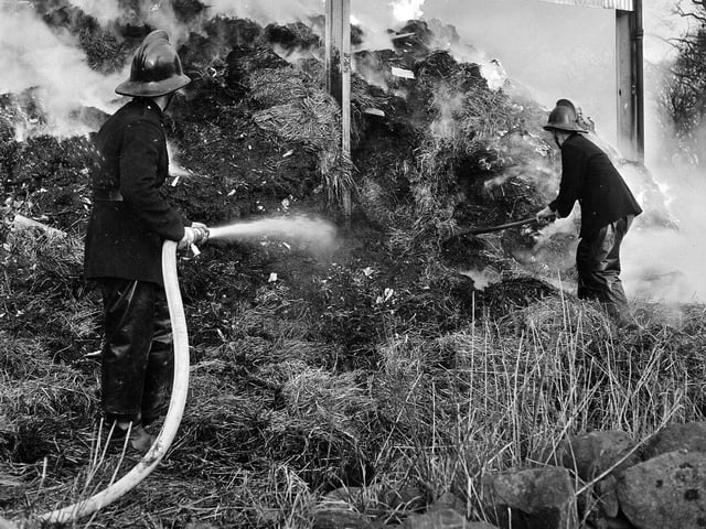 Firemen work to extinguish flames at Lord Rosebery's Currie estate in December 1965.