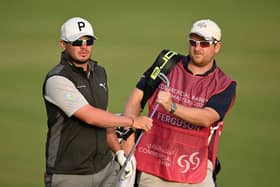 Ewen Ferguson hands a club to caddie Stephen Neilson during the Commercial Bank Qatar Masters at Doha Golf Club. Picture: Stuart Franklin/Getty Images.