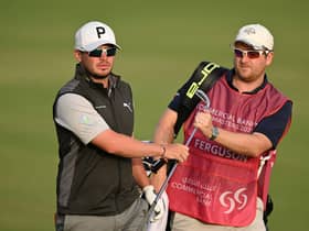 Ewen Ferguson hands a club to caddie Stephen Neilson during the Commercial Bank Qatar Masters at Doha Golf Club. Picture: Stuart Franklin/Getty Images.