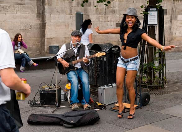 Busker Lawrence Glaister with reggae starlet Lil' Natt (Natalie Hendry) from local band Project Bona Fide.