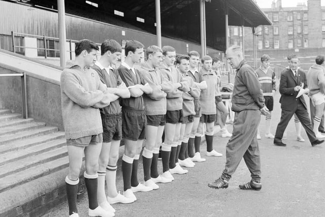 Trainer Johnny Harvey speaks to the Hearts football team before a training session at Tynecastle in July 1965.