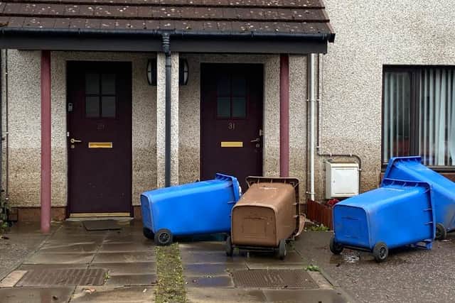 A video, taken by Aimee Miller as she and her young son were evacuated by A Scottish Fire and Rescue (SFRS) water rescue team, shows wheelie bins floating in the background, with abandoned cars left submerged in the water.