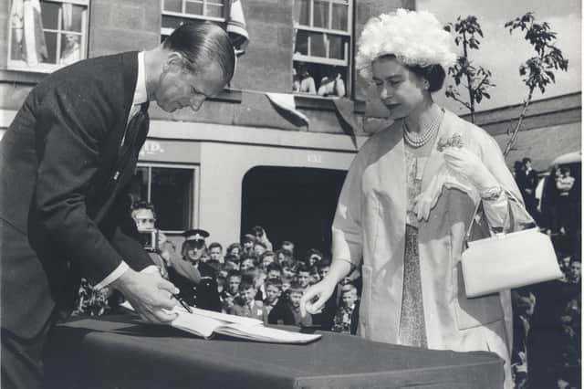 The Queen and the Duke of Edinburgh signing the visitors book while in Dalkeith in June 1961. Photo courtesy Midlothian Council Local Studies