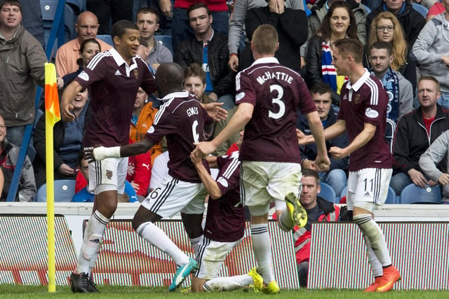Hearts team-mates mob Osman Sow after the striker struck a dramatic injury-time winner at Ibrox just seconds after Nicky Law had equalised for the hosts. Danny Wilson put the eventual Scottish Championship title-winners in front.