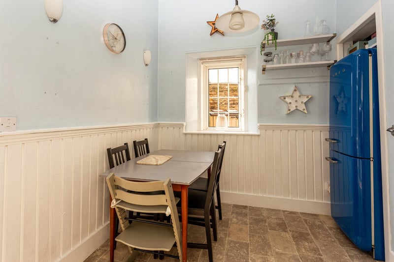 The kitchen provides ample space for a dining table.