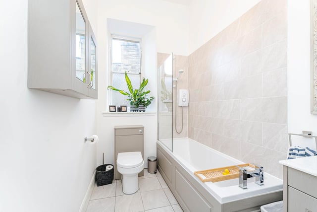 The contemporary family bathroom is situated off the main hall.