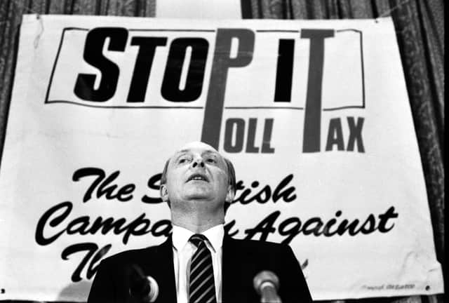 Party leader Neil Kinnock pictured in front of an anti-poll tax banner at a Scottish Labour Party conference on local government in Edinburgh in January 1988.