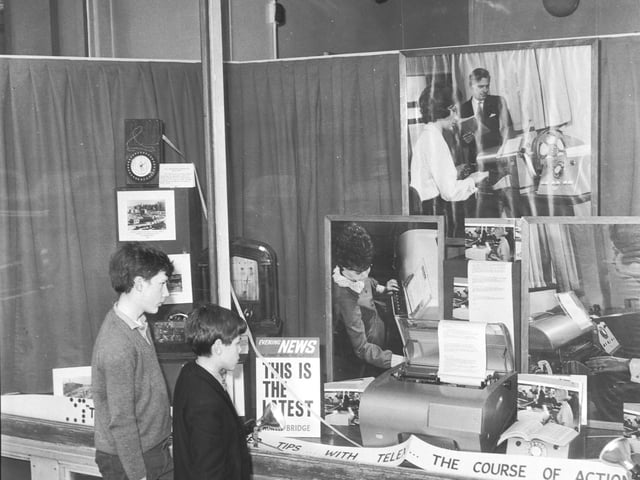 The new GPO telex machine, displayed at 118 George Street in March 1966, was interesting to these two young men.
