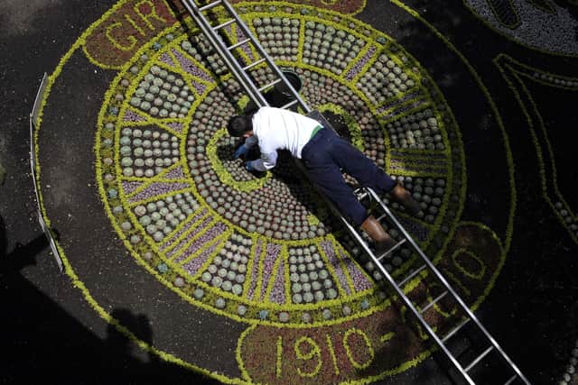 Workers put the finishing touches to the 2010 floral clock in Princes Street Gardens.  Picture: Ian Rutherford.