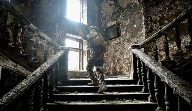 A Russian soldier climbs stairs at the Mariupol drama theatre, hit on March 16 by a Russian airstrike (Picture: Alexander Nemenov/AFP via Getty Images)