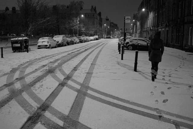 Edinburgh's streets and blanketed in snow.