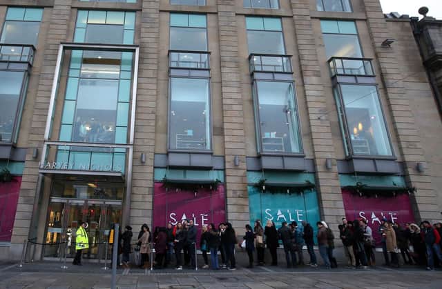 Shoppers queue outside Harvey Nichols in Edinburgh during a sale (Picture: Andrew Milligan/PA Wire)
