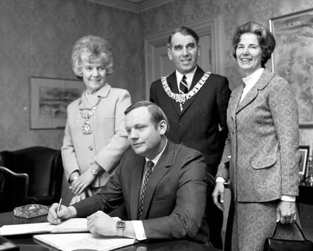 Astronaut Neil Armstrong signs the visitors' book at Edinburgh City Chambers in March 1972, watched by the then Lord Provost James McKay and his wife (Picture: Denis Straughan)