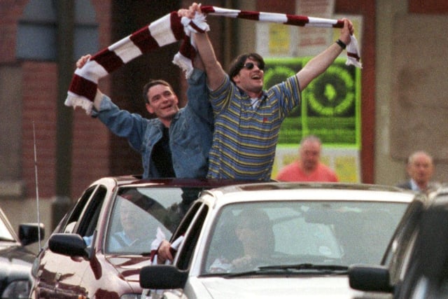 Hearts fans at Tynecastle celebrate their team winning the Tennents Scottish Cup in 1998, after beating Rangers 2-1 in Glasgow.