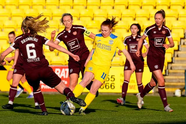 Hearts' Tegan Browning  battles with Hibernian's Colette Cavanagh during this month's SWPL1 derby. The Edinburgh rivals will be competing for players off the pitch with semi-pro contracts