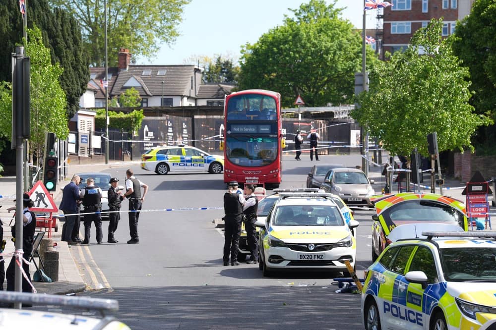 Police officers at the scene in Golders Green, north-west London, after two men - one aged in his 70s and another in his 30s - were stabbed on Wednesday morning