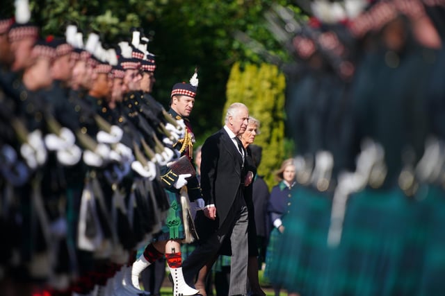 King Charles III and the Queen Consort inspect the Guard of Honour before the Ceremony of the Keys at the Palace of Holyroodhouse, Edinburgh. Picture date: Monday September 12, 2022.