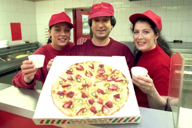 Ali Jaghoori and assistants Michelle Williams (left) and Lorraine Carney from Pizzarama in Hylton Road with their fruit pizza. But in which year?