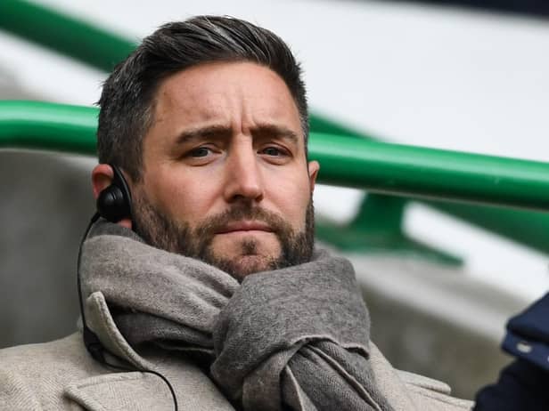 Lee Johnson, serving a one-game touchline ban, watches on from the directors' box at Easter Road