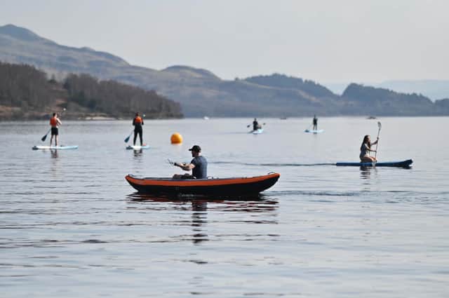 Kayakers and paddle boarders at Luss on Loch Lomond on Saturday. Picture: John Devlin