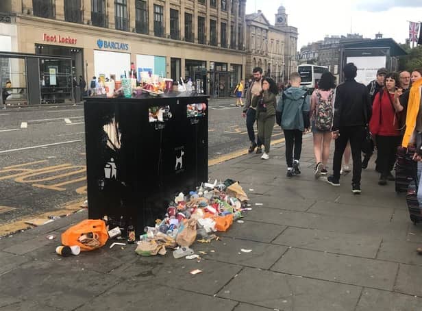 An overflowing bin in Princes Street - tourists are said to be taking photographs of Edinburgh's growing mounds of rubbish.