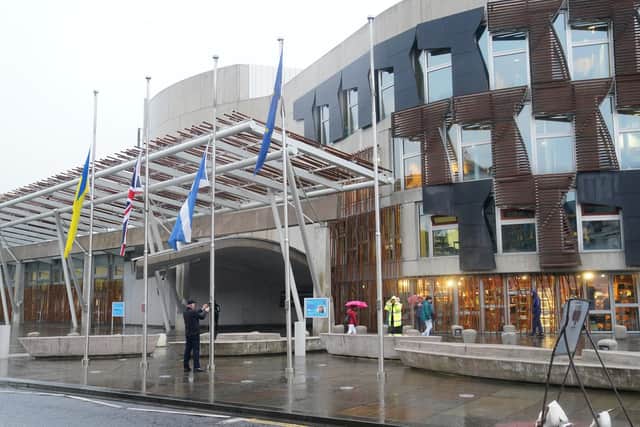 Flags were lowered to half mast outside the Scottish Parliament at Holyrood following the announcement of the Queen's death. Picture: Jane Barlow.