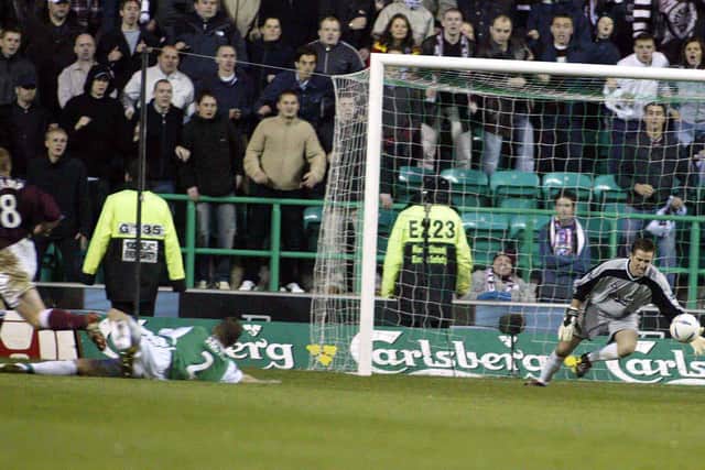 Stamp fires past Nick Colgan in front of the jubilant Hearts support at Easter Road. Picture: SNS