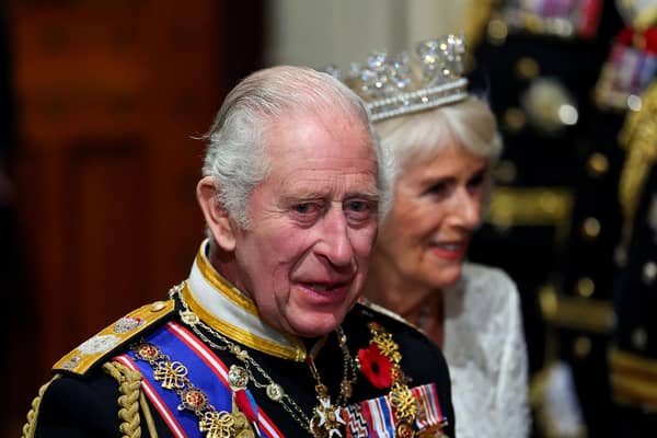 King Charles III and Queen Camilla walking through the Members' Lobby at the Palace of Westminster following the State Opening of Parliament in the House of Lords