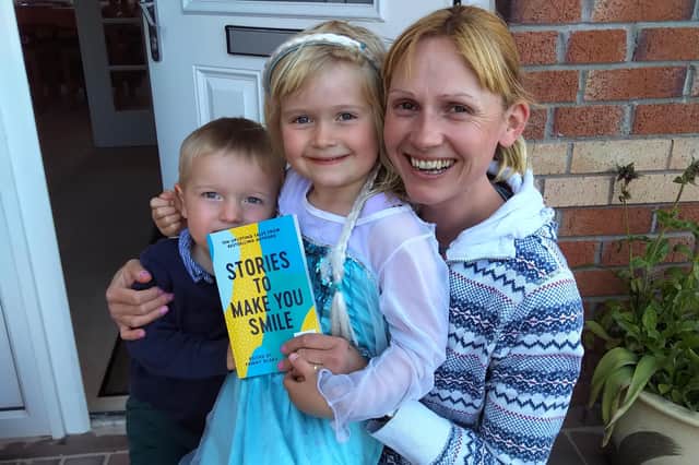 Edith Cameron with her children Alice and Rory, with their free book.